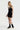 Sleek short jumpsuit black in model front side view - JUV