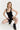 Sleek short jumpsuit black in model front view - JUV